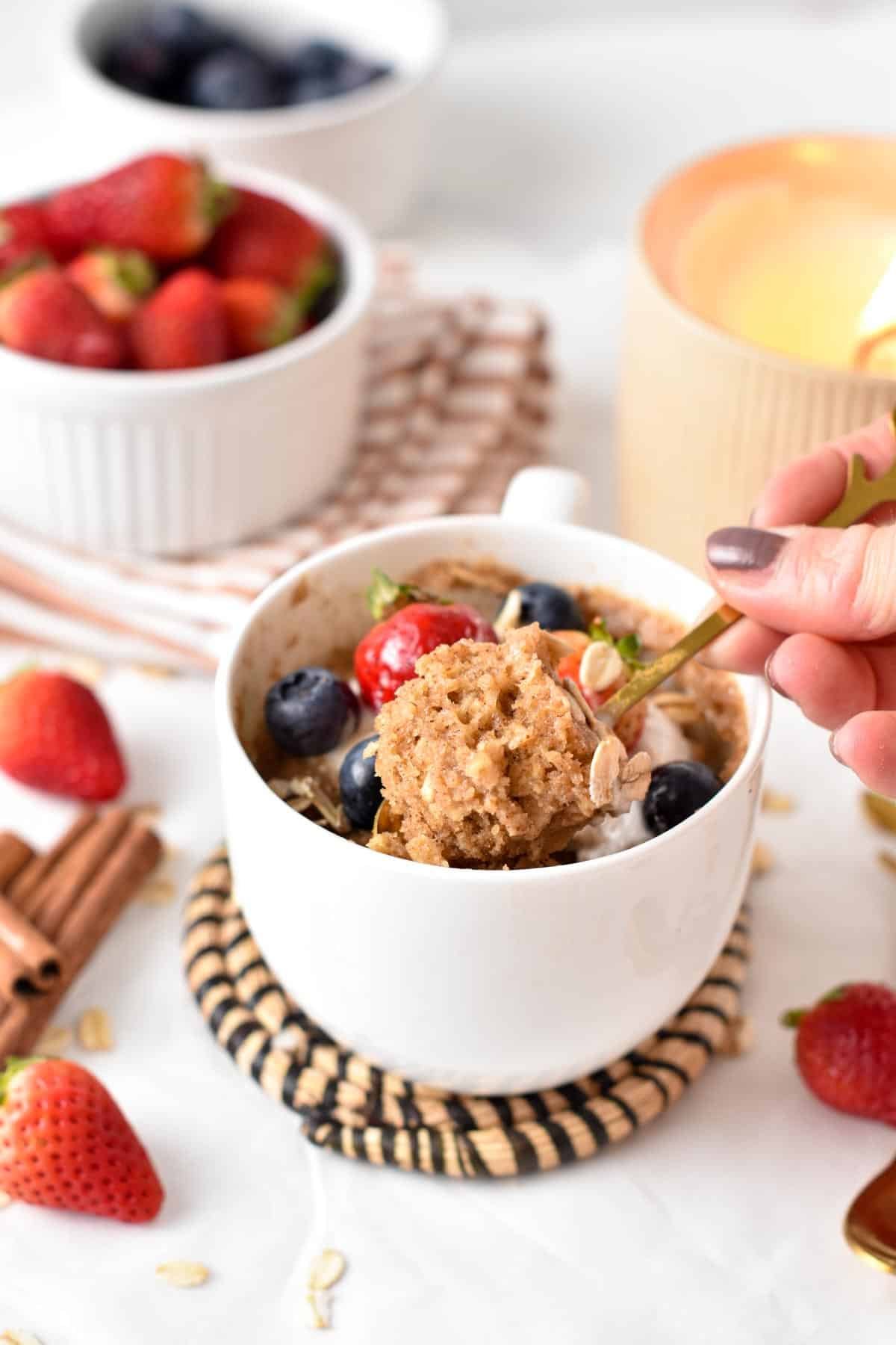 Spoon taking a portion of Oatmeal Mug Cake.