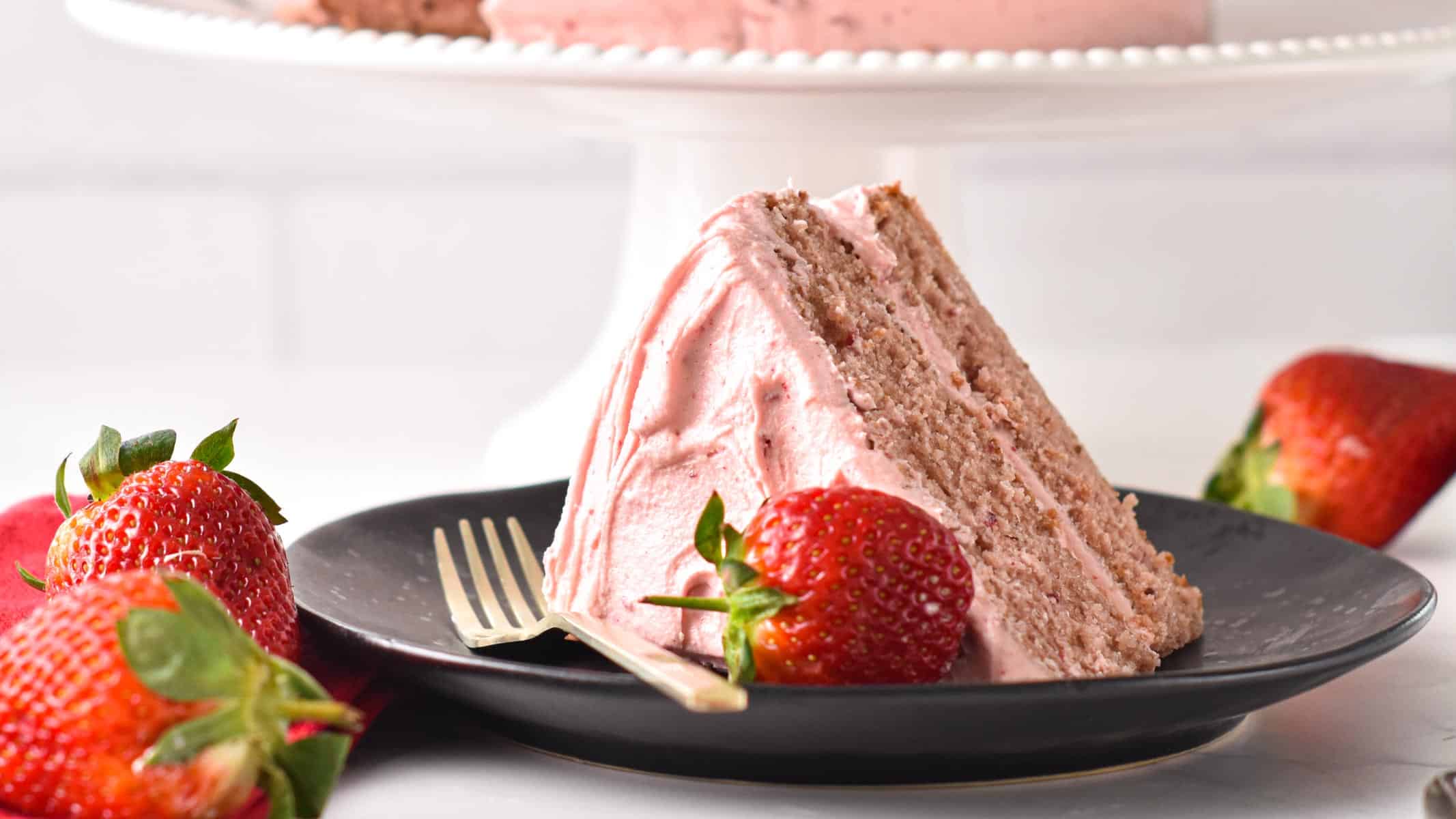 Slice of Vegan Strawberry Cake on a black plate/