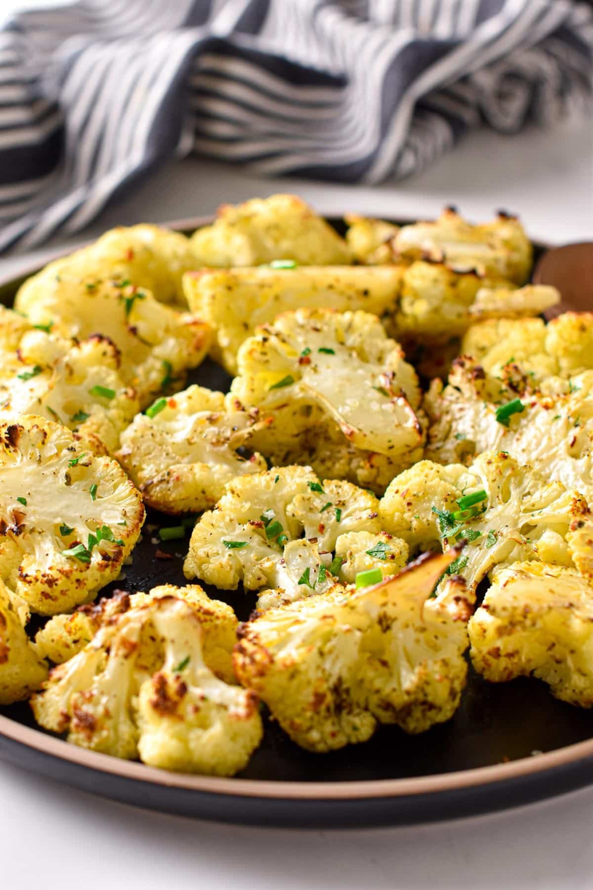 Air Fryer Cauliflower on a black plate.