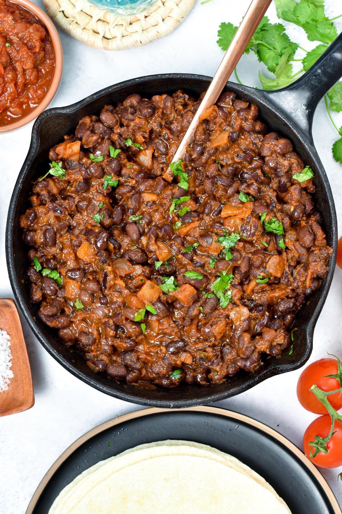 Mexican Black Beans in a large cast-iron frying pan.