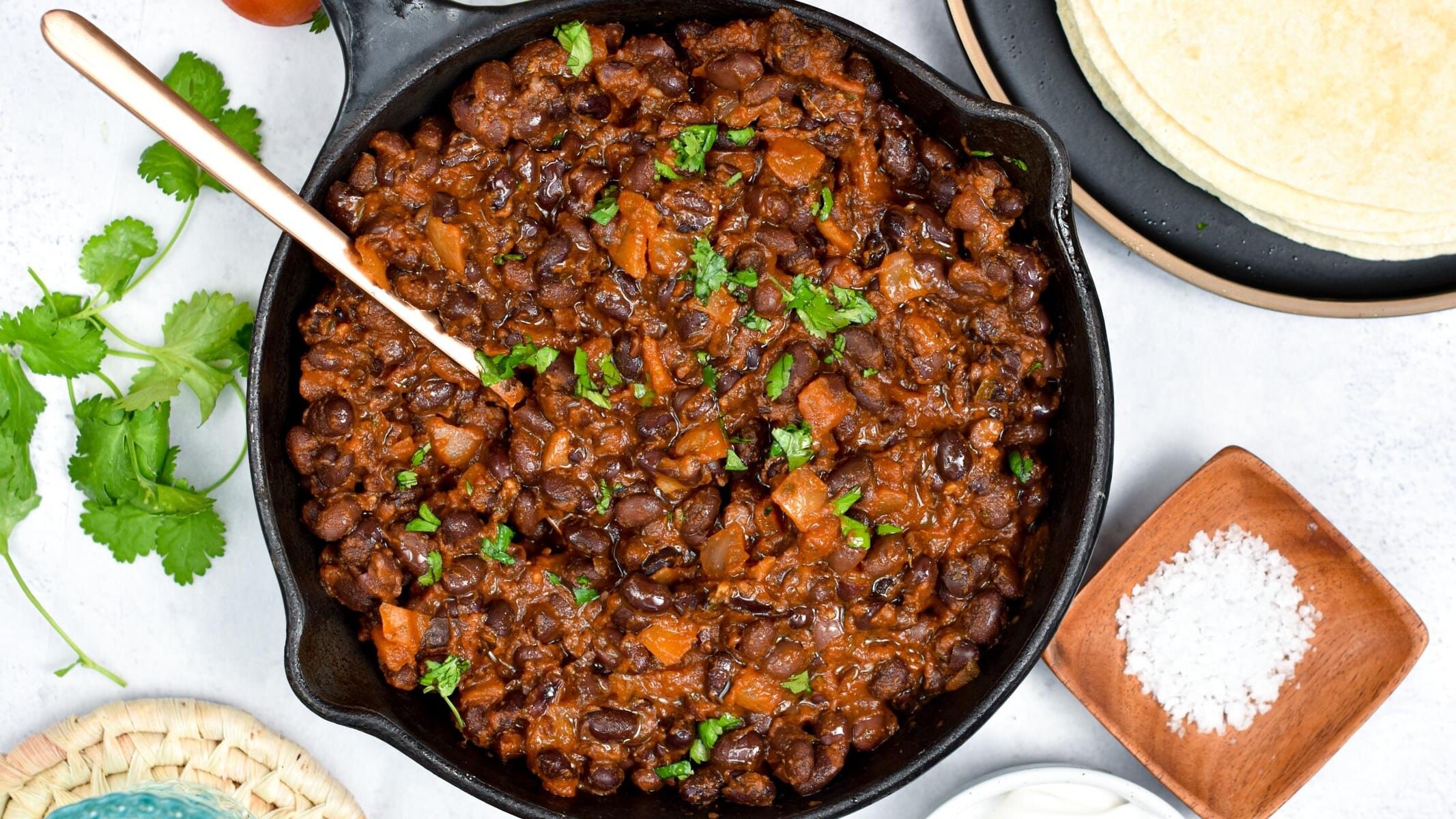 Mexican Black Beans decorated with cilantro.