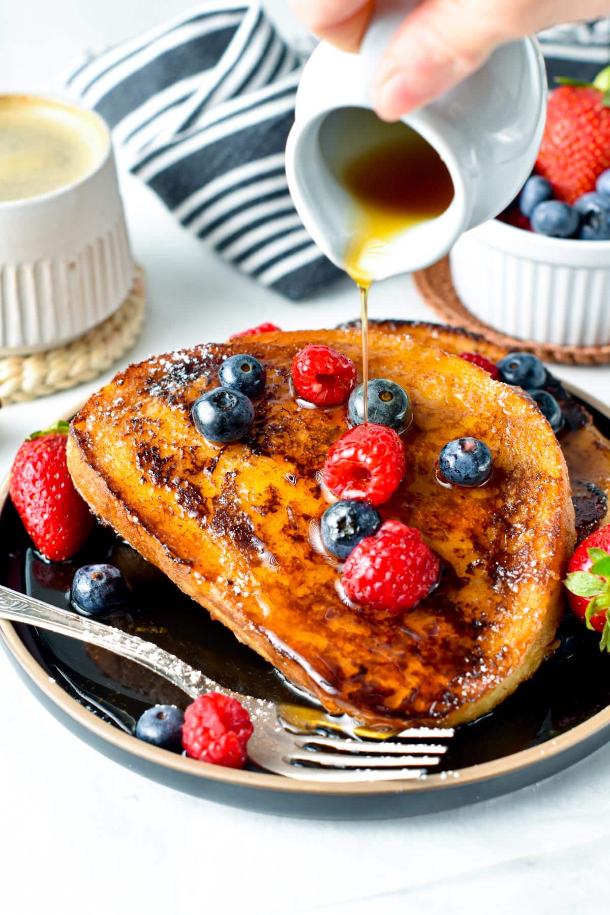 Eggless French Toast with maple syrup poured on them.