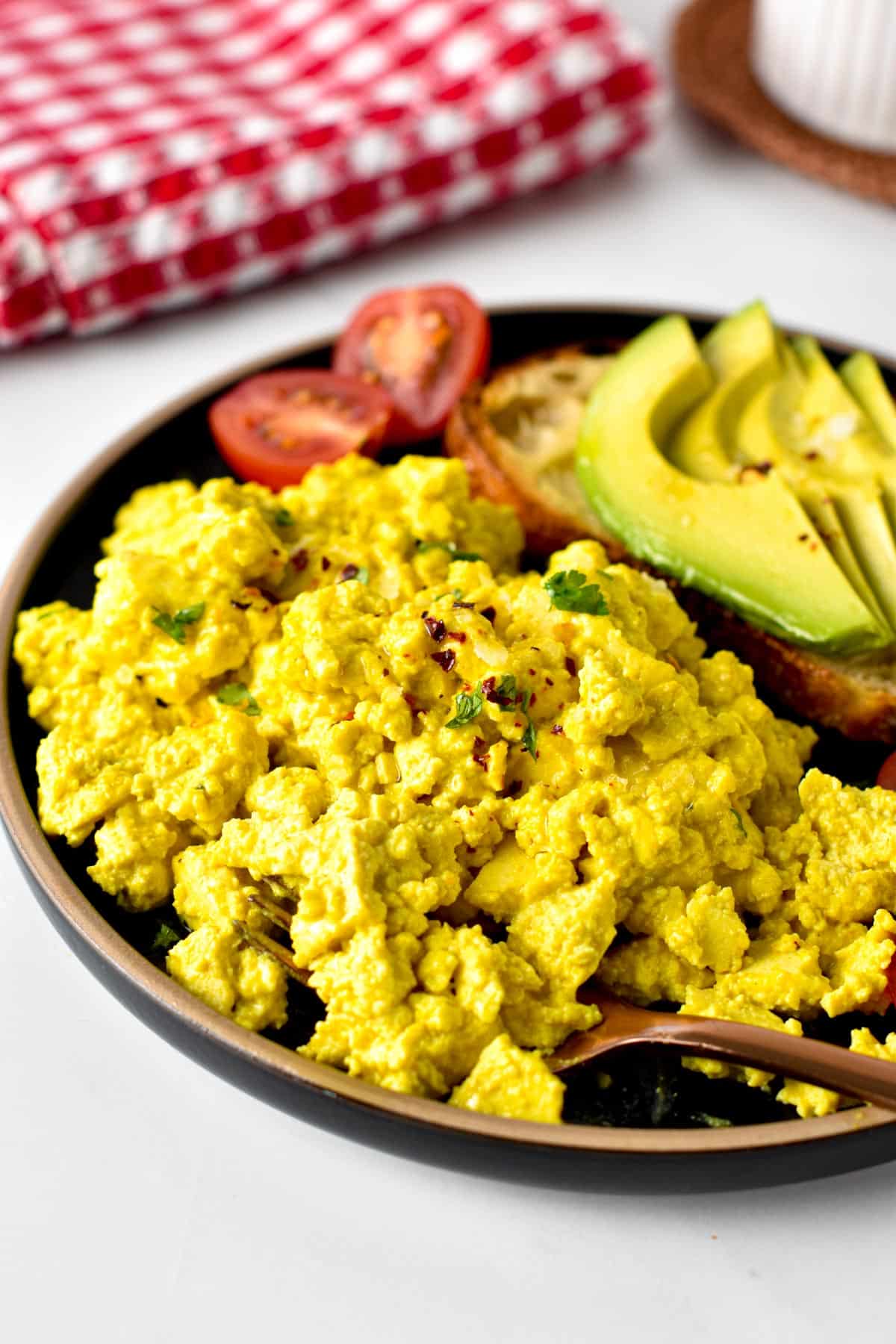 This Tofu Scramble recipe is an egg-free scramble made out tofu with such a delicious cheesy, eggy flavor that nobody will guess it's eggless.