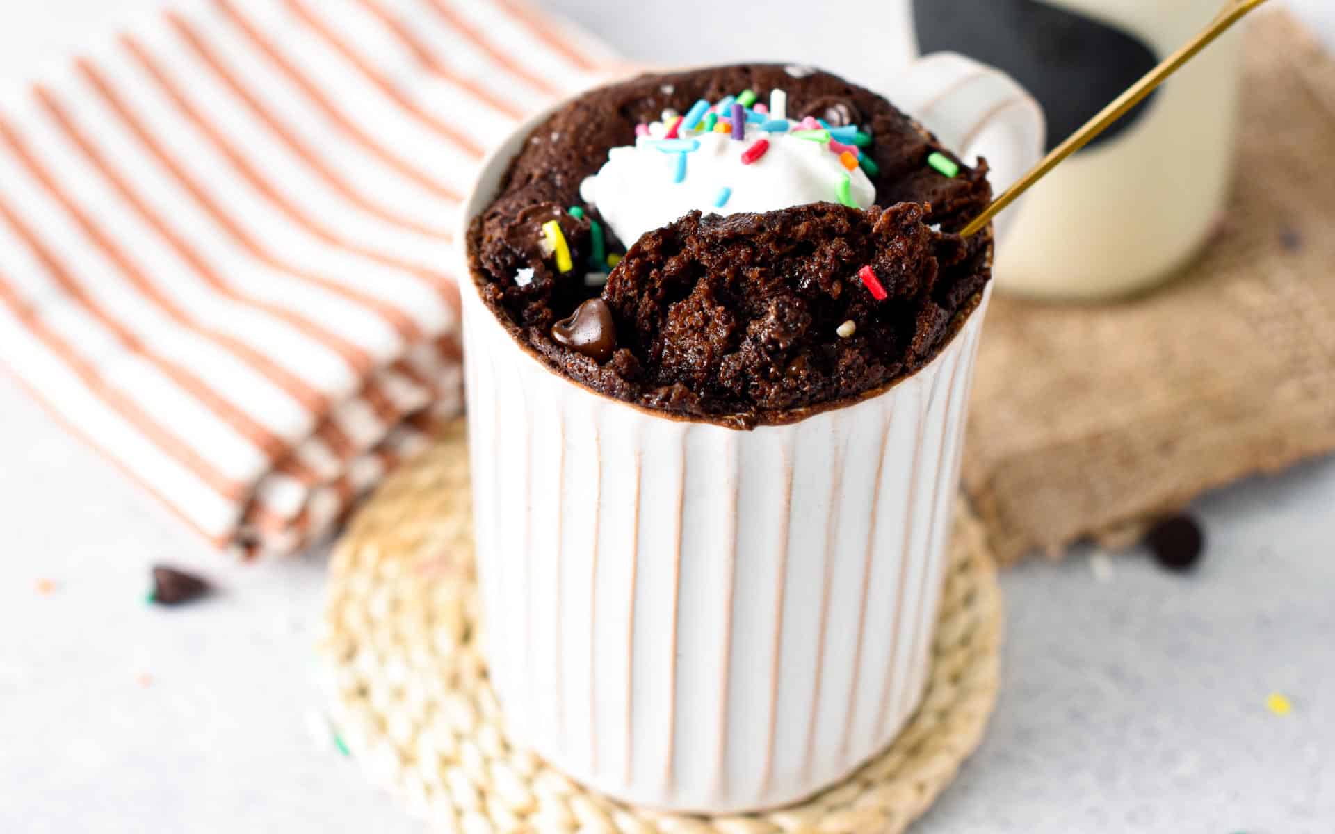 This Vegan Gluten-free Mug Cake recipe is a delicious single serve chocolate cake baked in your microwave in 90 seconds to fix your sweet tooth. Plus, this is a vegan oil-free mug cake too, perfect if you are looking for oil-free baking recipe.