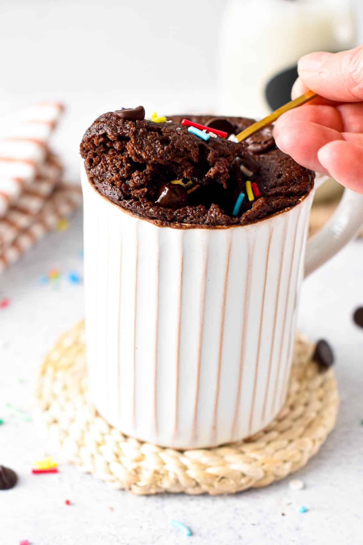 This Vegan Gluten-free Mug Cake recipe is a delicious single serve chocolate cake baked in your microwave in 90 seconds to fix your sweet tooth. Plus, this is a vegan oil-free mug cake too, perfect if you are looking for oil-free baking recipe.