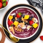 This Acai Bowl recipe is a creamy refreshing smoothie bowl packed with anti-oxidants and vitamin C. Plus, it takes barely 5 minutes to prepare this easy healthy breakfast and it's also naturally vegan and gluten-free.