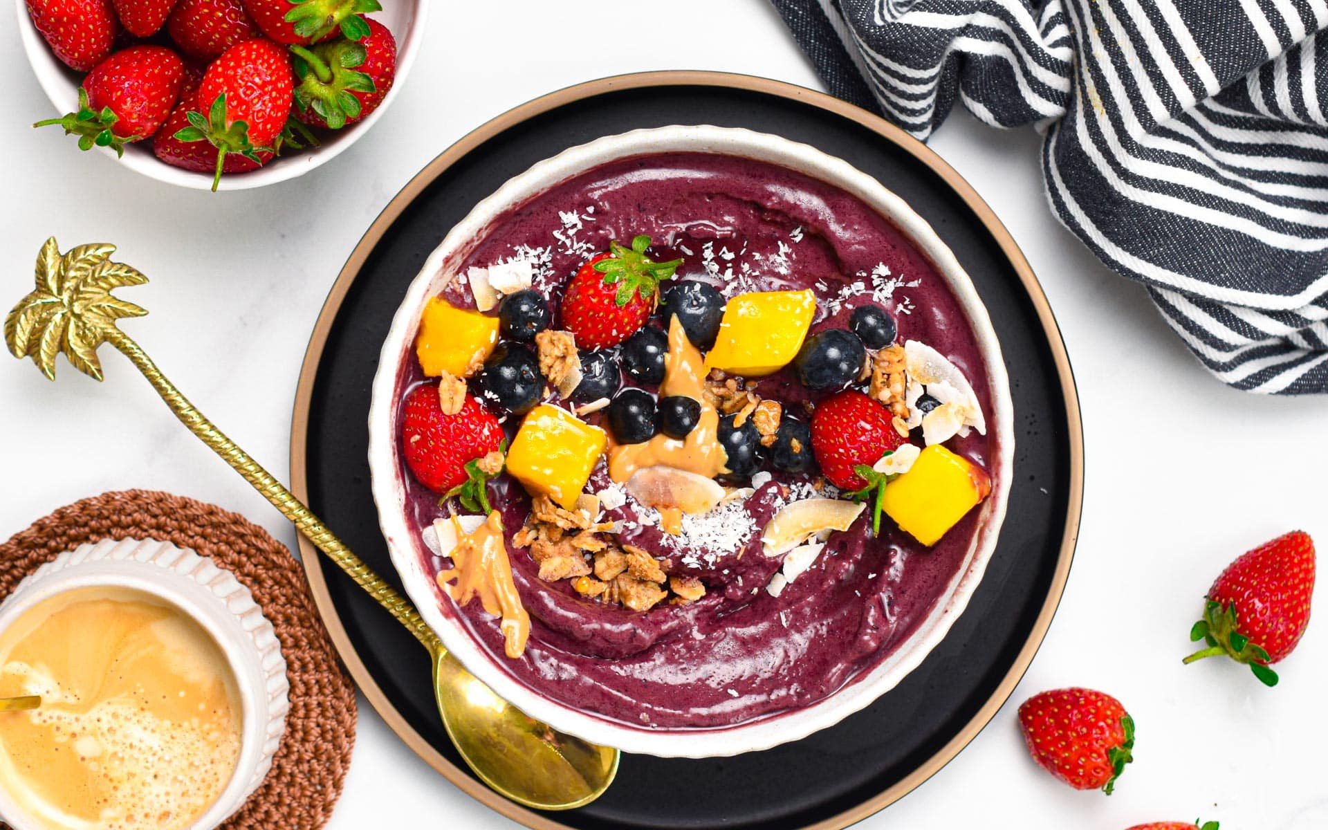 Vegan acai bowl decorated with fresh fruits.