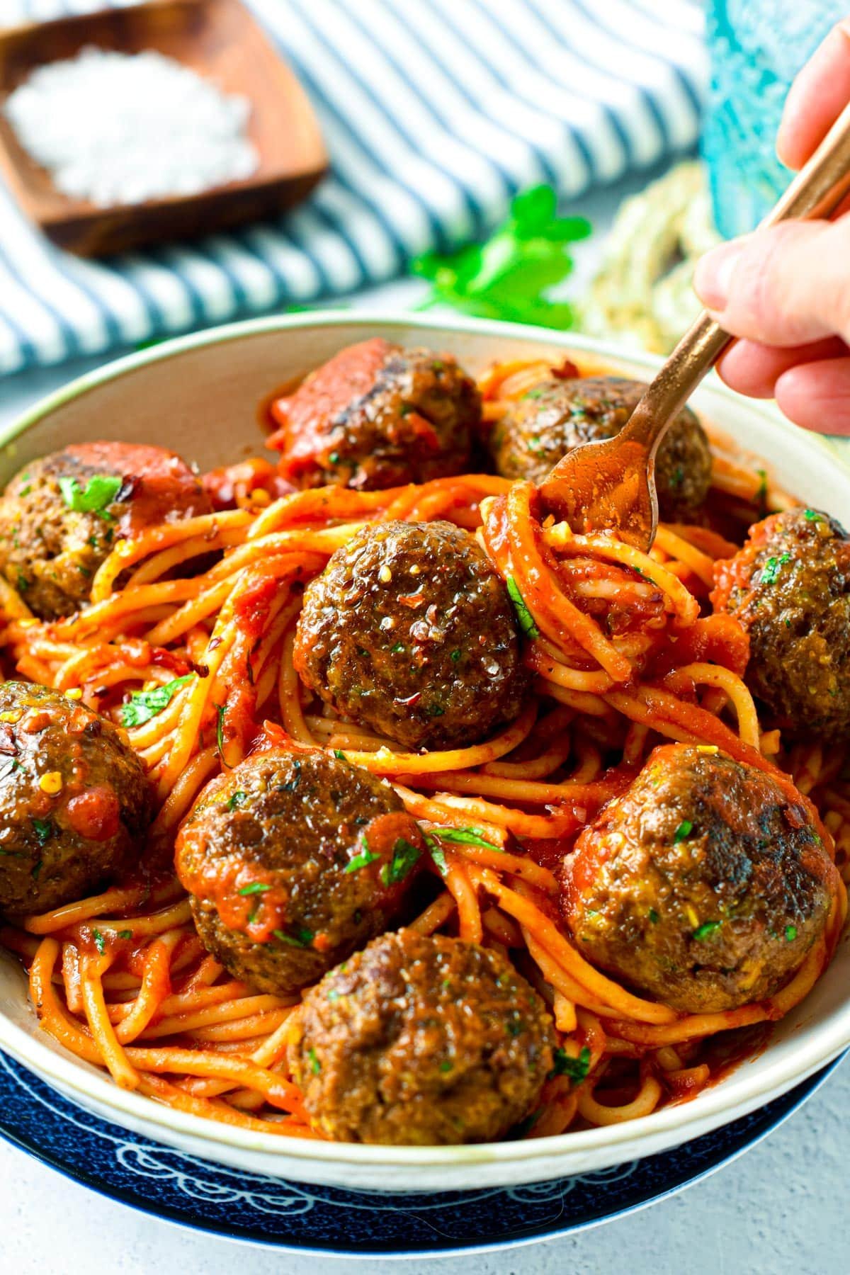 Grabbing a serving of spaghetti and TVP meatballs with forks.