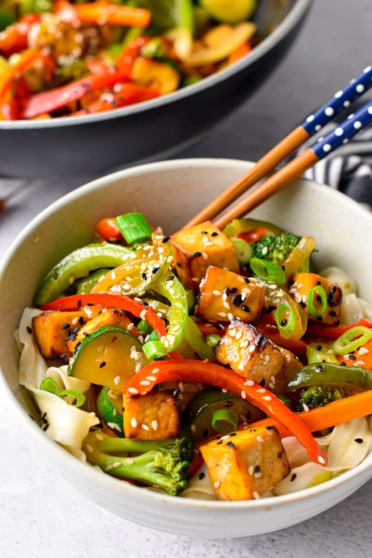 Vegan Stir Fry in a small bowl with chopsticks.