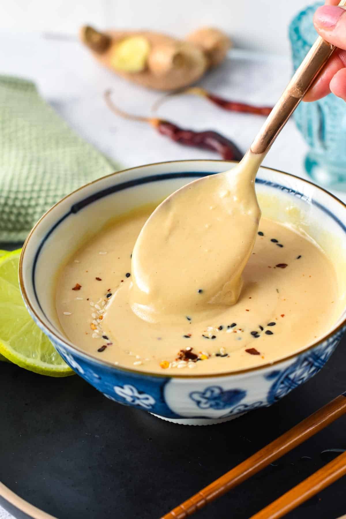 Miso Tahini Dressing in a bowl with a spoon.