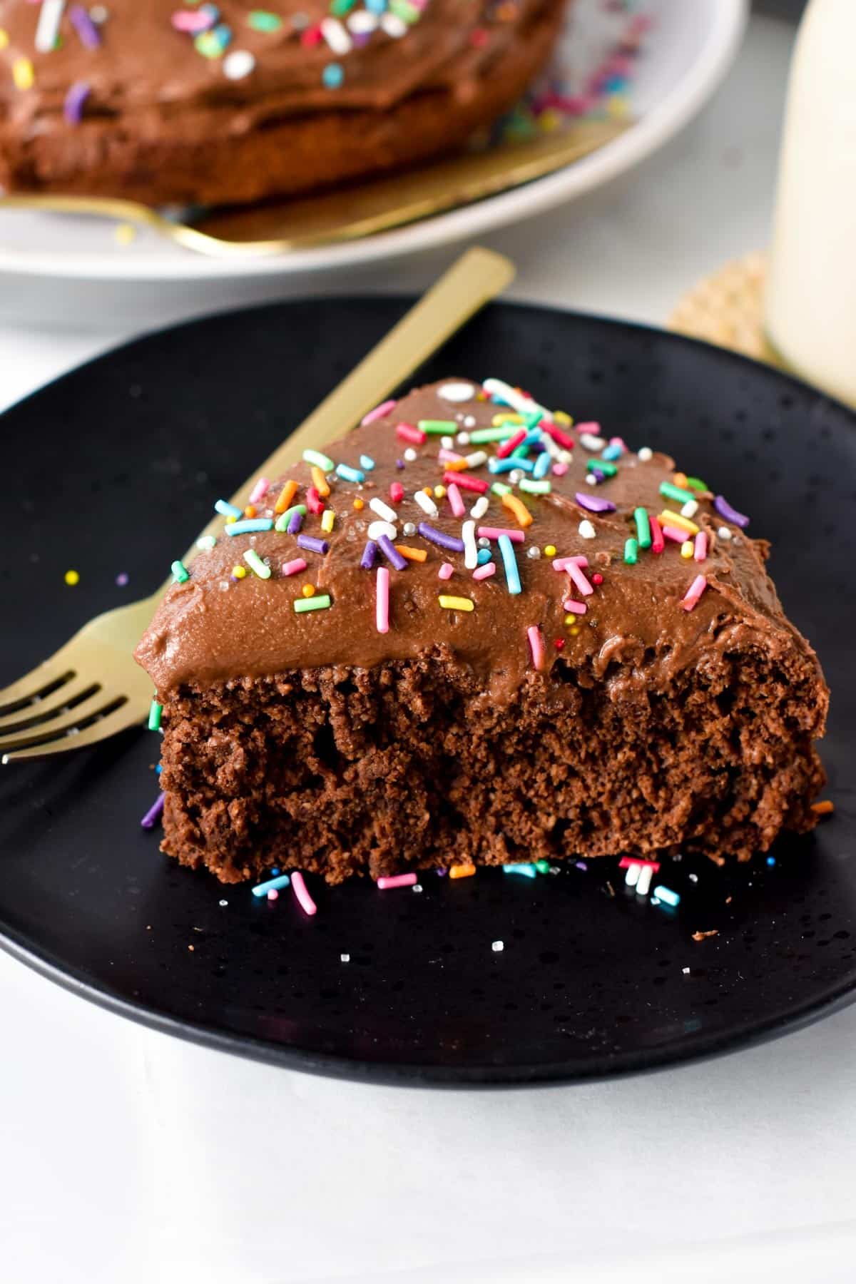 A slice of Protein Cake on a black plate.