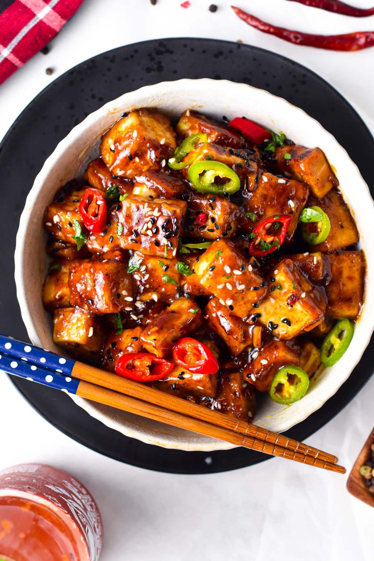 This Szechuan Tofu will fix your spicy Chinese food craving! Delicious crispy tofu pieces coated with a spicy Sichuan sauce packed with garlic, chili pepper, and Schezuan pepper.