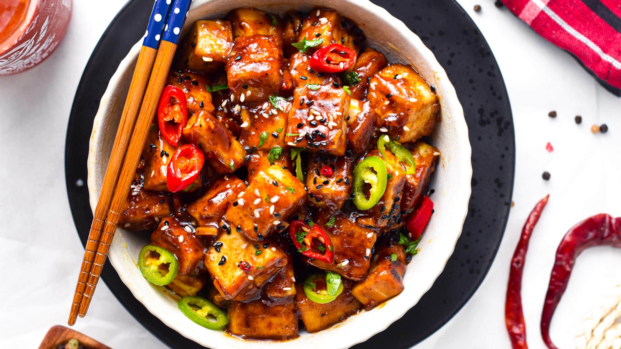 This Szechuan Tofu will fix your spicy Chinese food craving! Delicious crispy tofu pieces coated with a spicy Sichuan sauce packed with garlic, chili pepper, and Schezuan pepper.