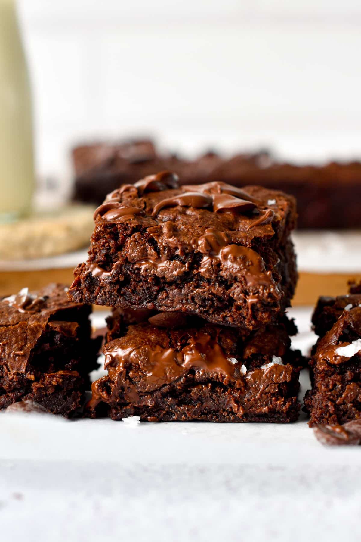 Gooey, chocolate Vegan Brownies stacked on a table.