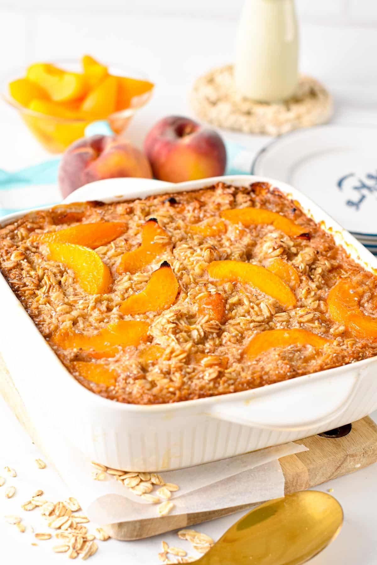 Peach Baked Oatmeal ready on a ceramic baking dish.