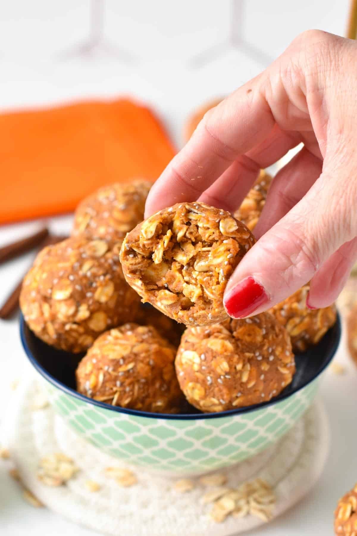 Pumpkin Protein Balls showing one half bitten.