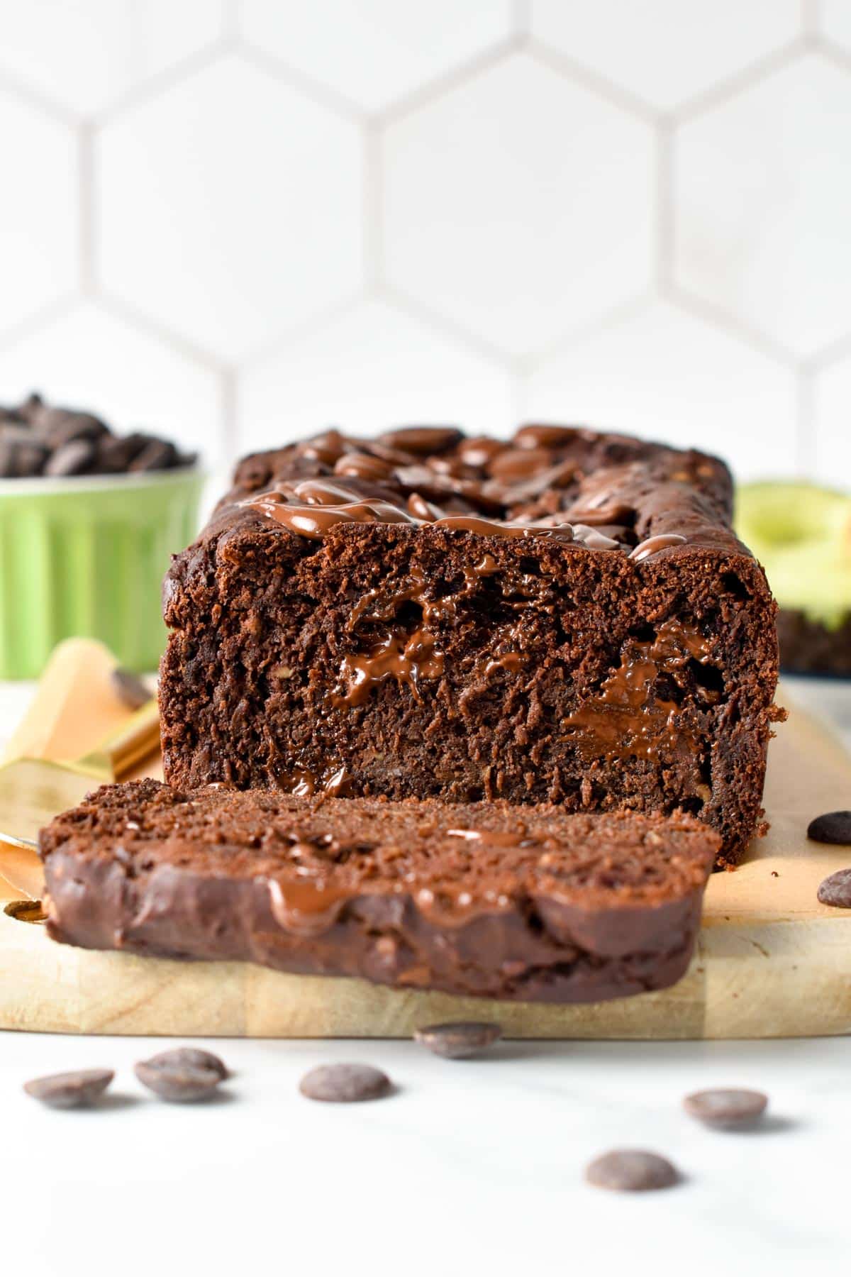 Chocolate avocado bread sliced on a chopping board.