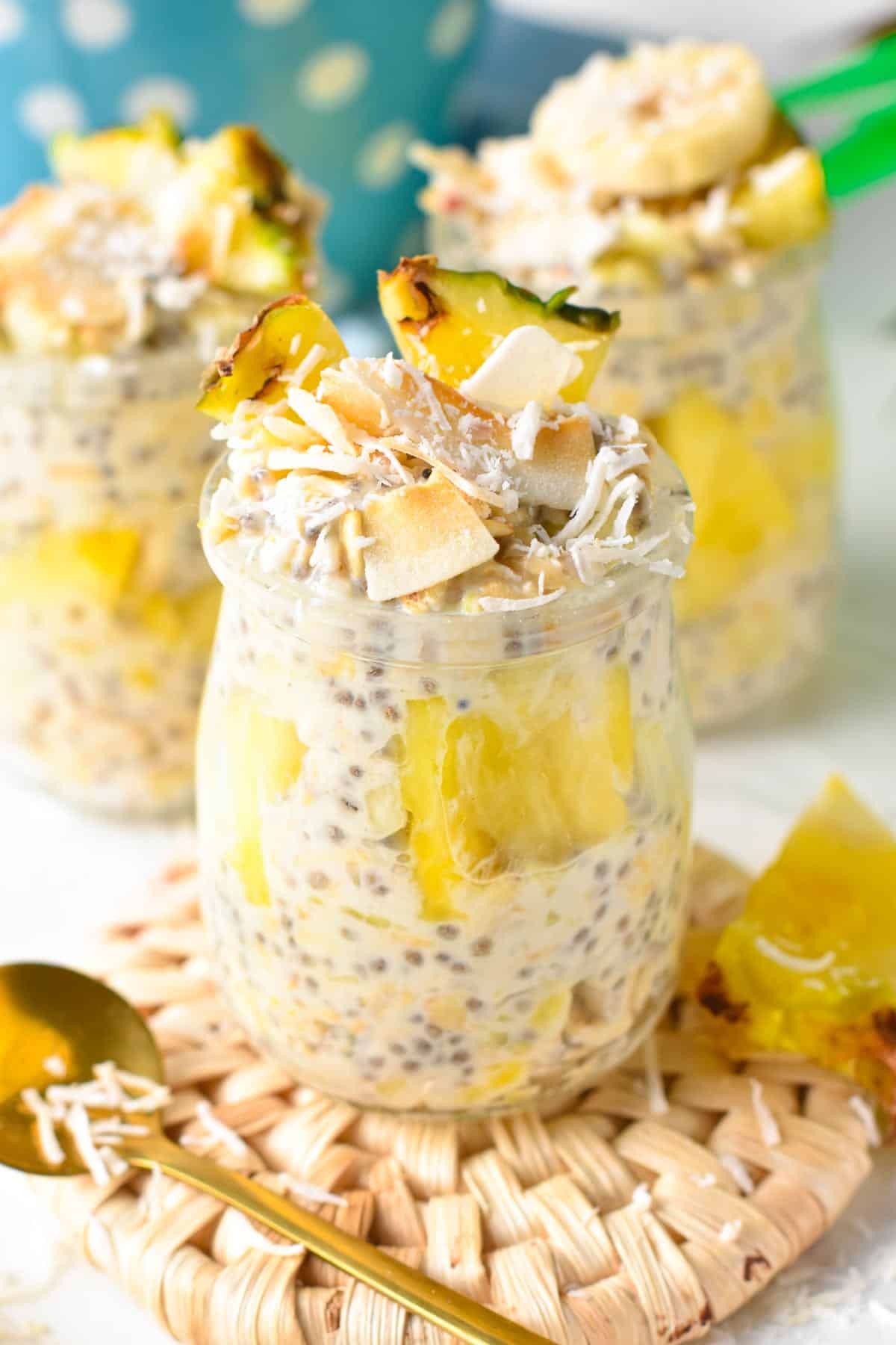 Pina Colada Overnight Oats decorated with shredded coconut and pineapple chunks.