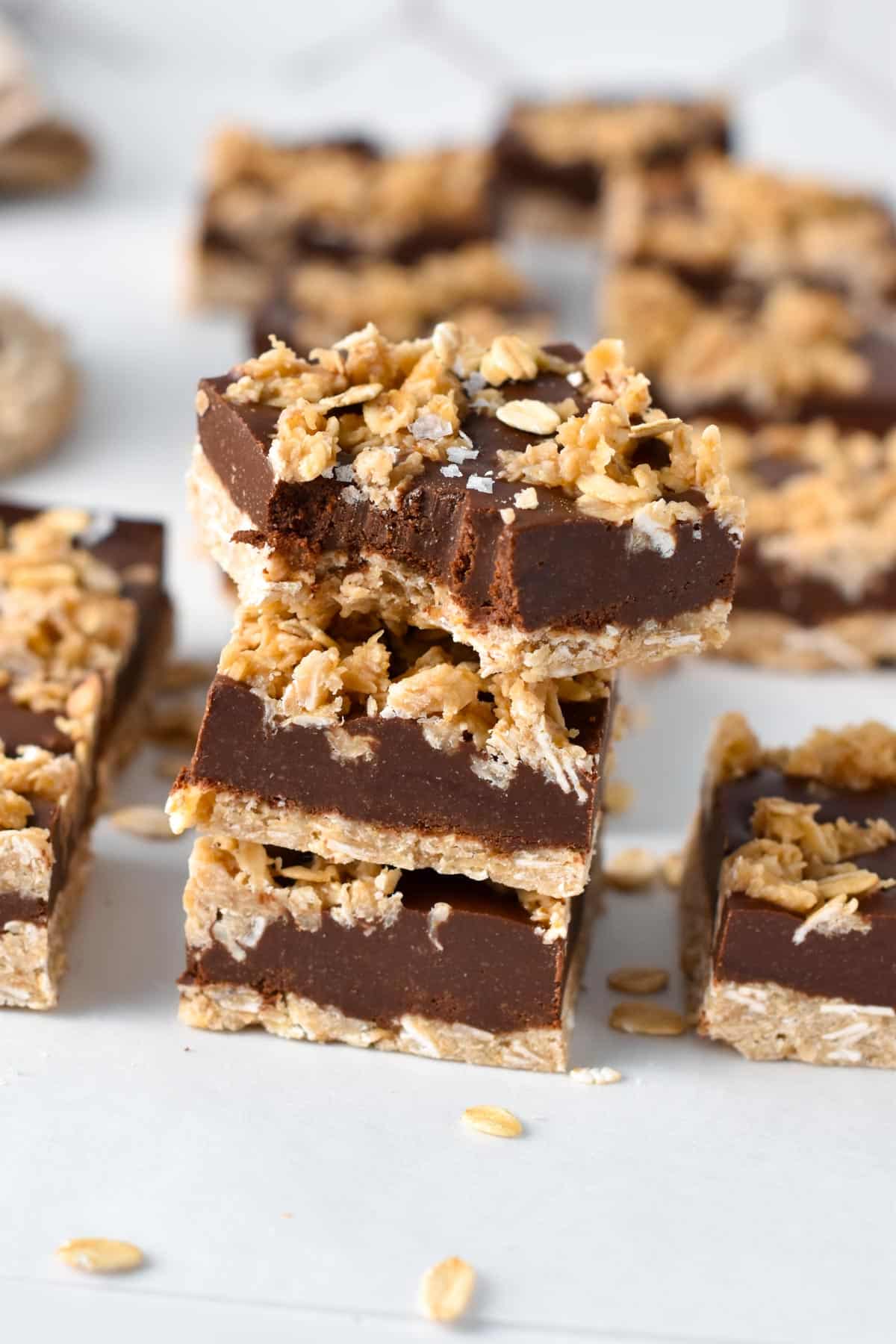 No-Bake Chocolate Peanut Butter Oatmeal Bars stacked on a table.