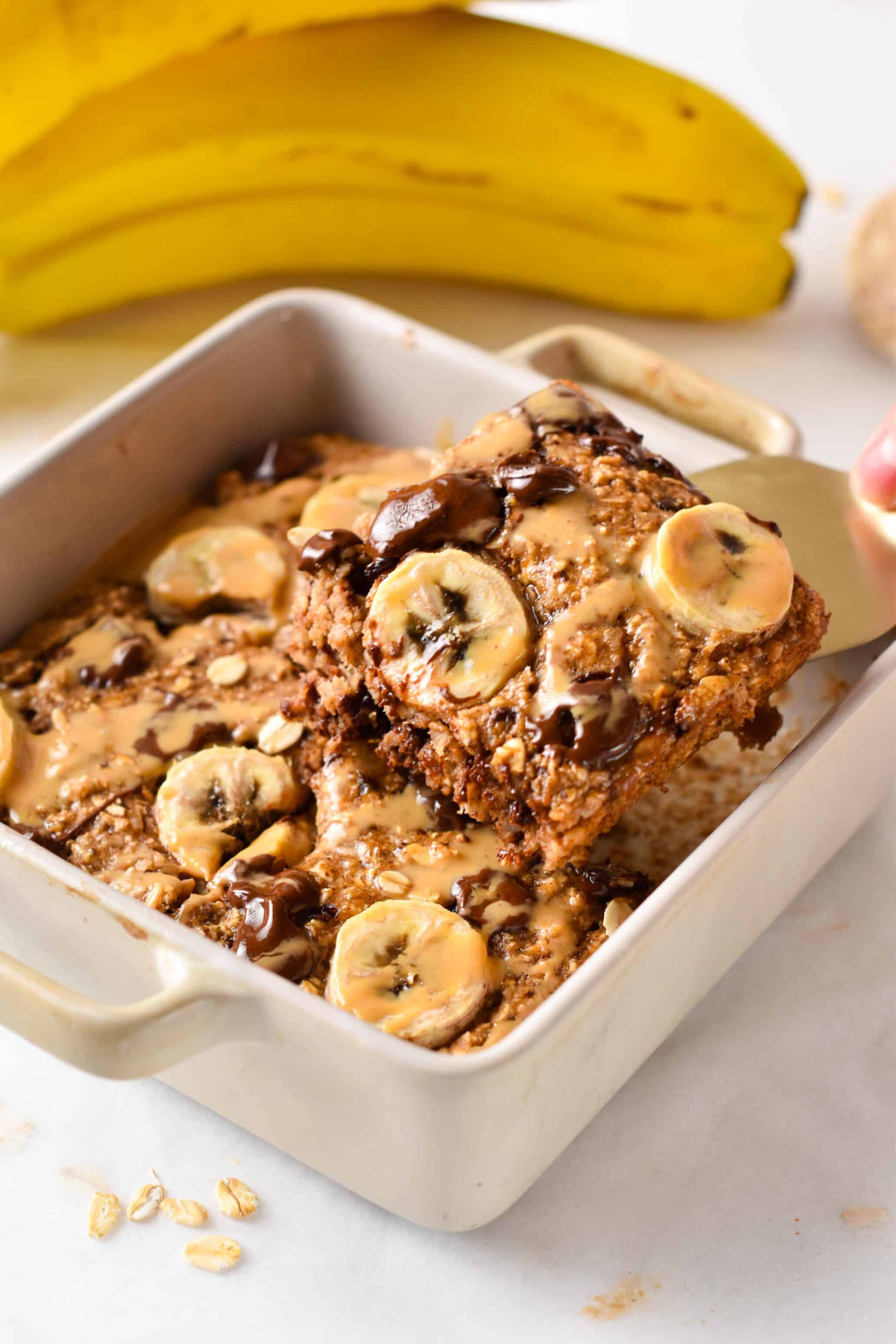 Banana Bread Baked Oats in a white ceramic dish.