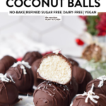 a stack of chocolate coconut balls with one balls cut halfway showing the coconut mixture inside