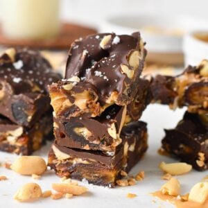 pieces of date bark made with Medjool dates, peanuts, peanut butter and melted dark chocolate
