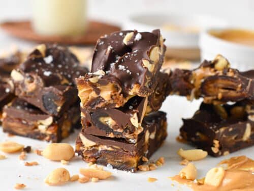 pieces of date bark made with Medjool dates, peanuts, peanut butter and melted dark chocolate