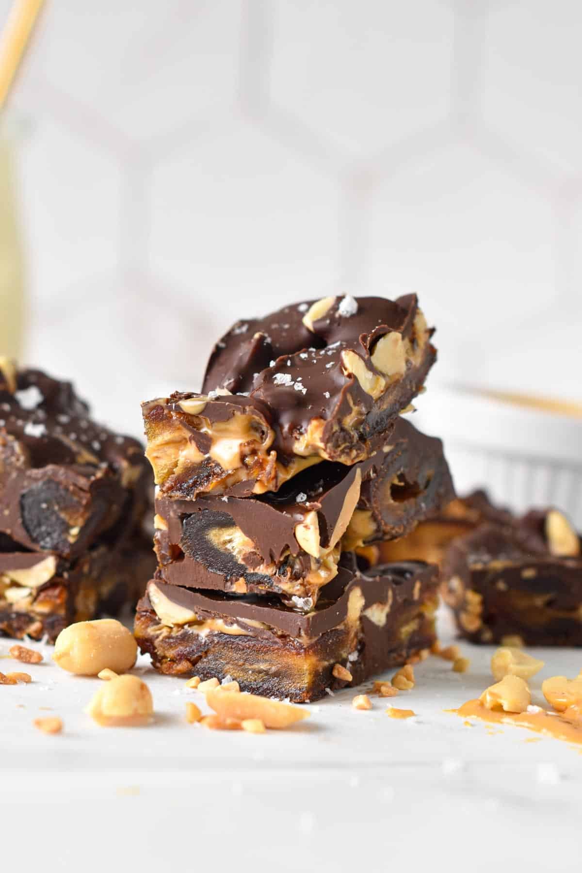 Pieces of date bark made with Medjool dates, peanuts, peanut butter and melted dark chocolate.