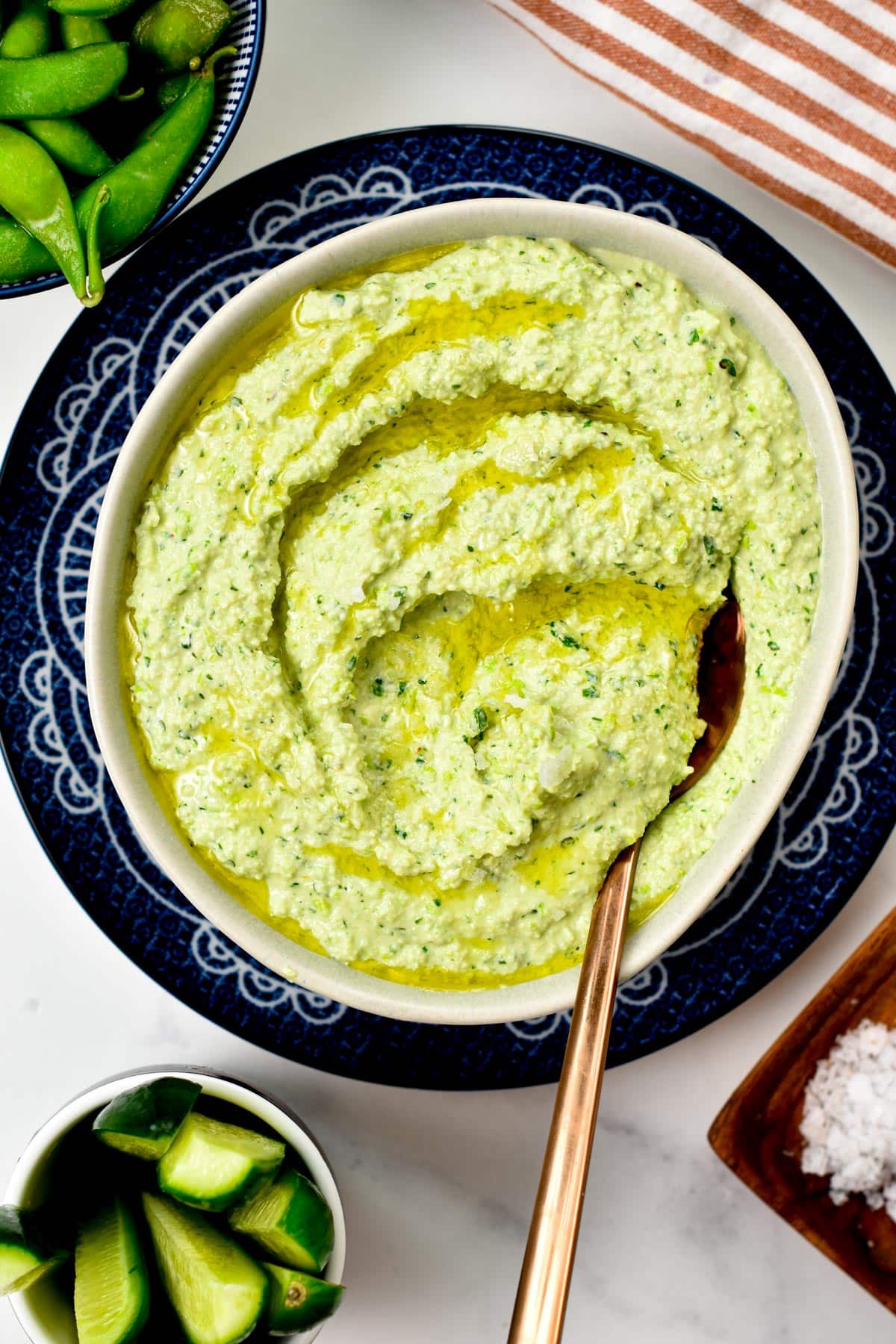 Edamame Hummus with a golden spoon.