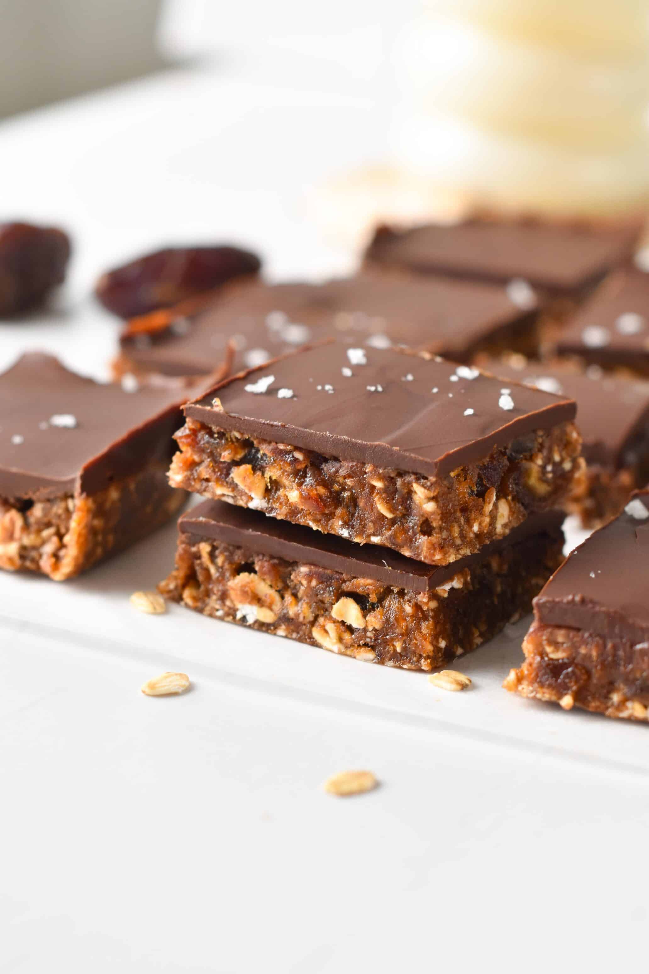 Healthy date bars cut into square, stacked and decorated with salt flakes.