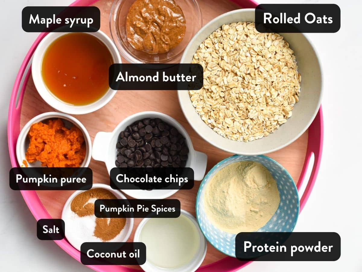 Ingredients for pumpkin protein cookies presented in small bowls on a serving tray