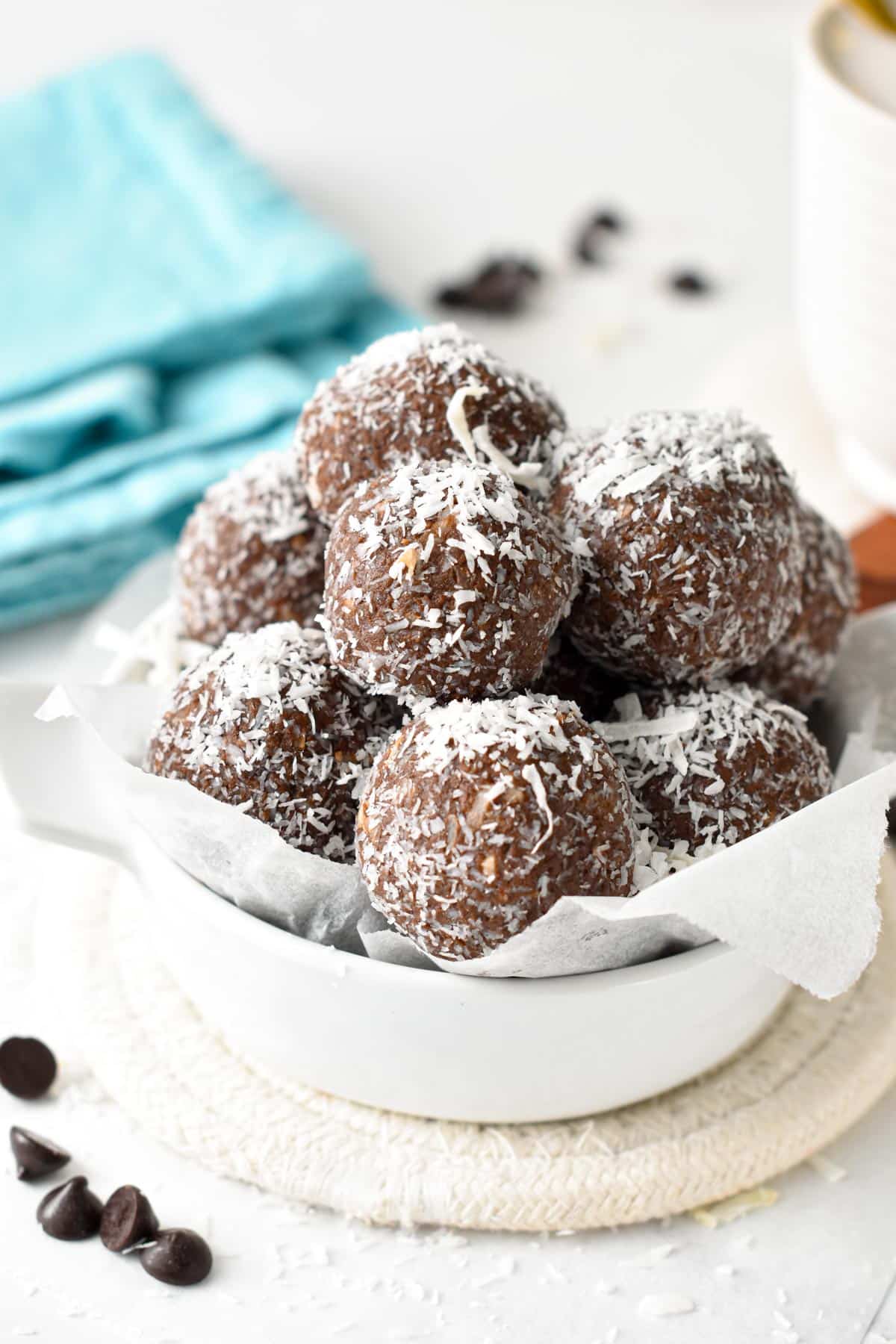 A bowl filled with chocolate coconut protein balls.