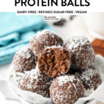 a bowl filled with chocolate coconut protein balls