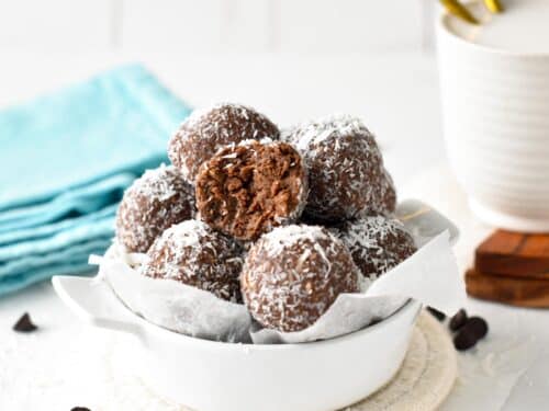 a bowl filled with chocolate coconut protein balls