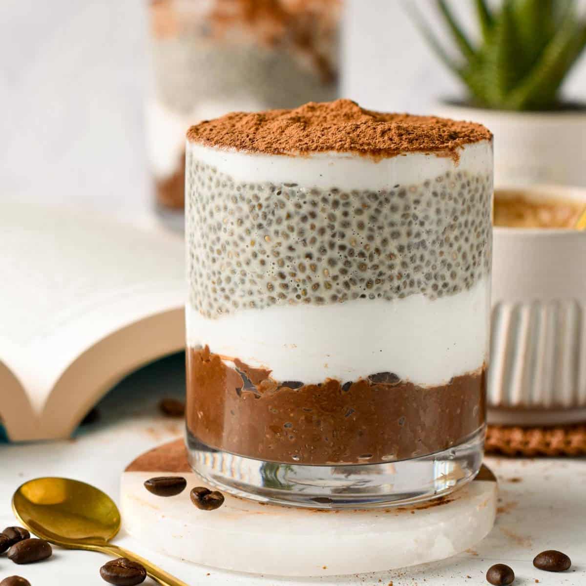 Tiramisu Chia Pudding next to a golden spoon.