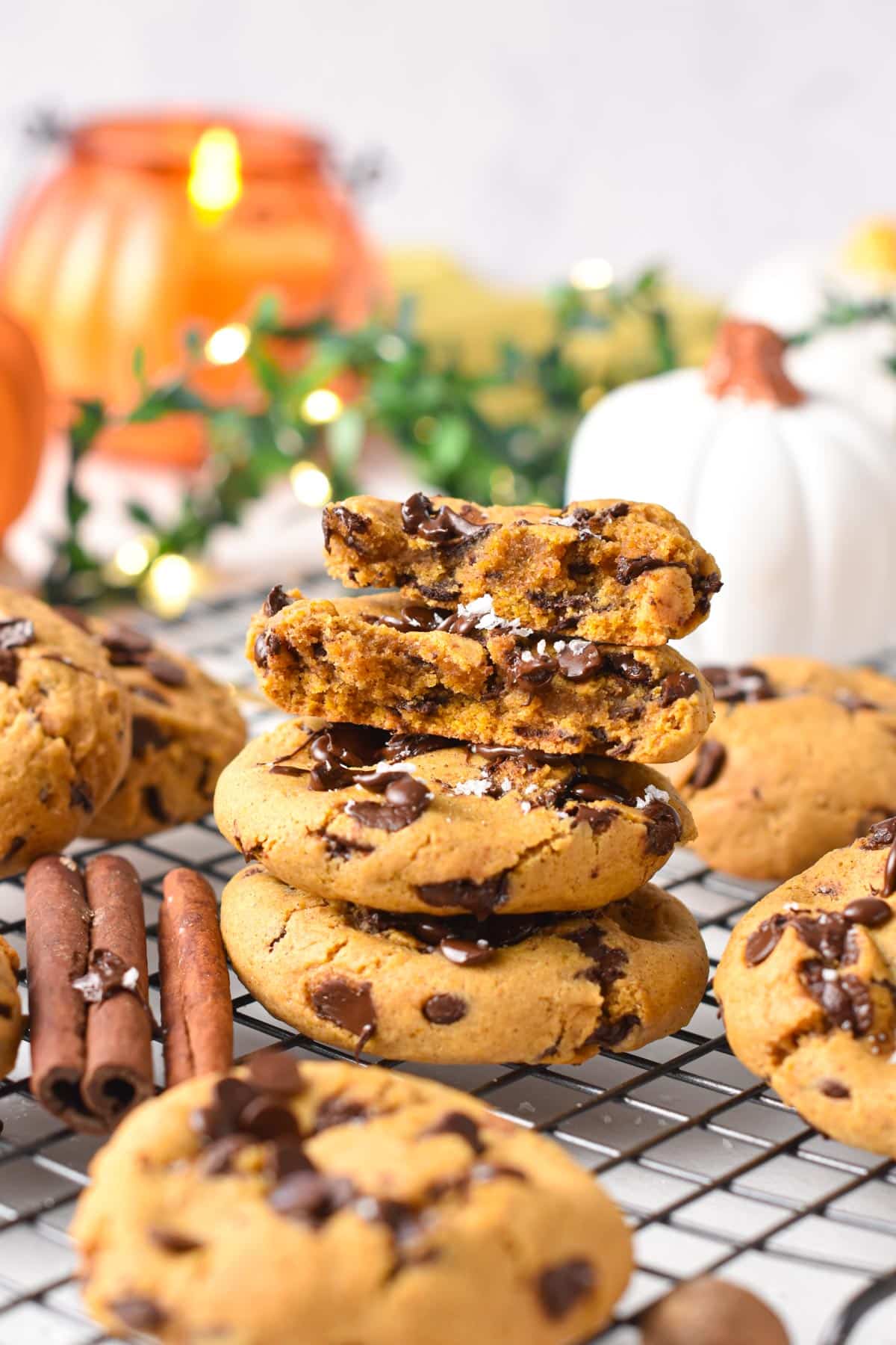 A stack of Vegan Pumpkin Chocolate Chips Cookies with pumpkin decor in the background.