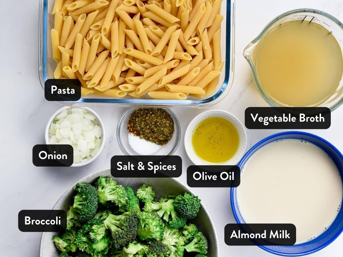 Ingredients for Vegan Broccoli Pasta in various plates, pans, and bowls with labels.