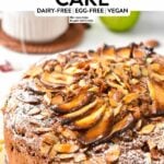 a vegan apple cake topped with sliced almonds and apple slices