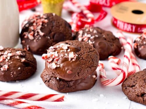 Vegan Chocolate Peppermint Cookies decorated with candy cane in front of Christmas Decor.