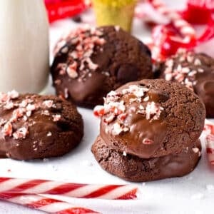 Vegan Chocolate Peppermint Cookies decorated with candy cane in front of Christmas Decor.