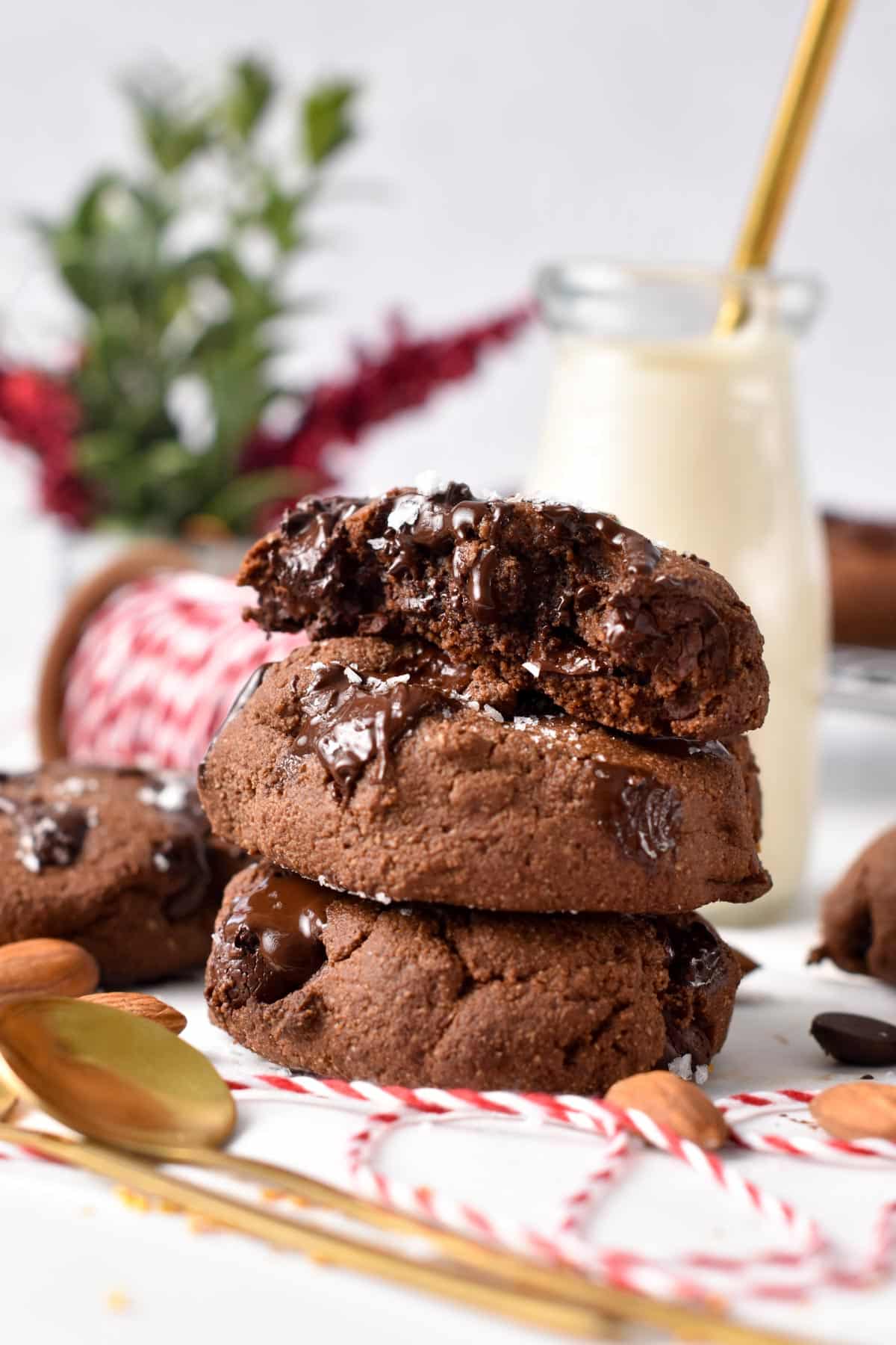 A stack of chocolate almond flour cookies with melted chocolate chips.