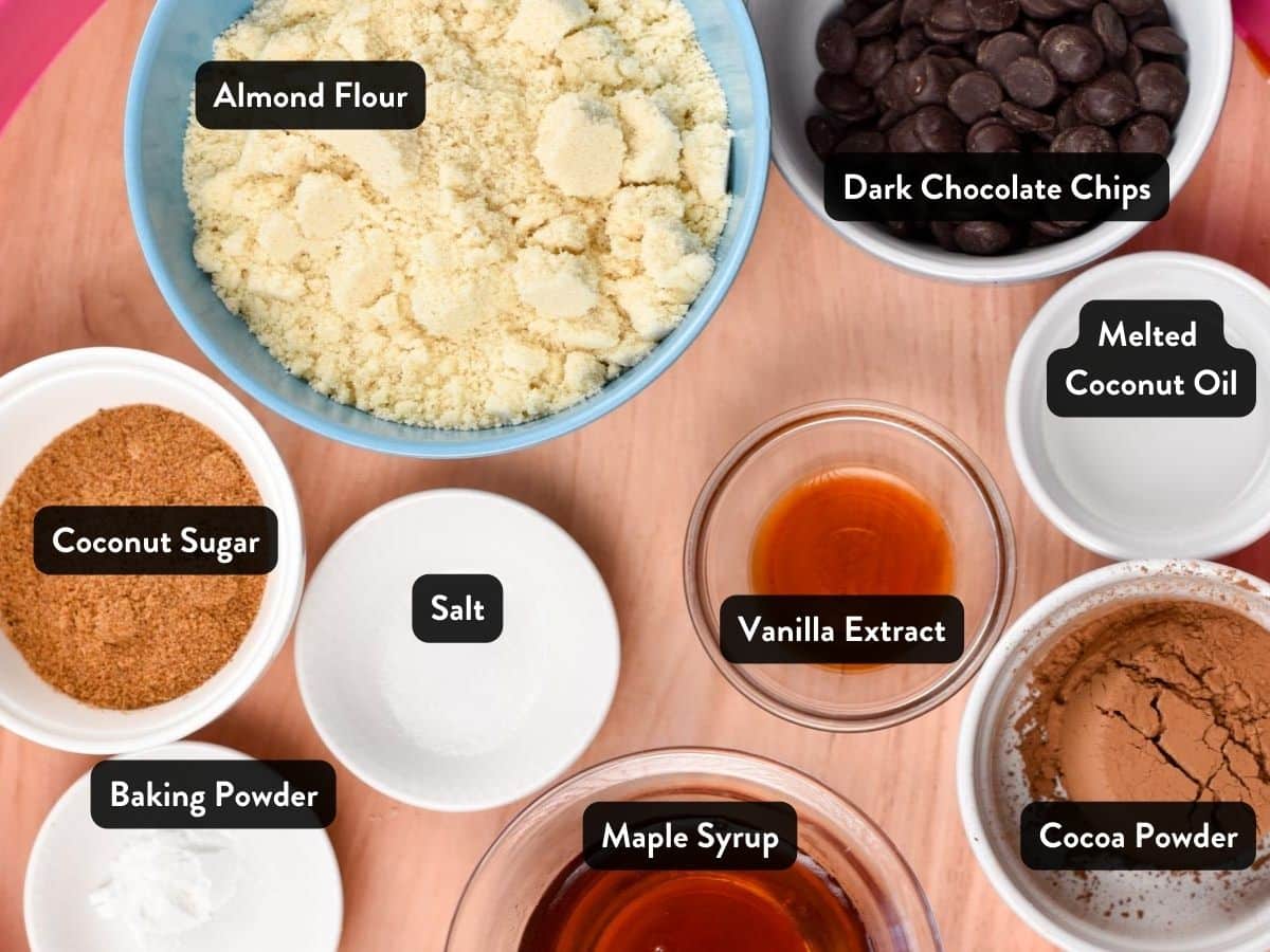 Ingredients for Almond Flour Chocolate Cookies in various bowls and ramekins with labels.