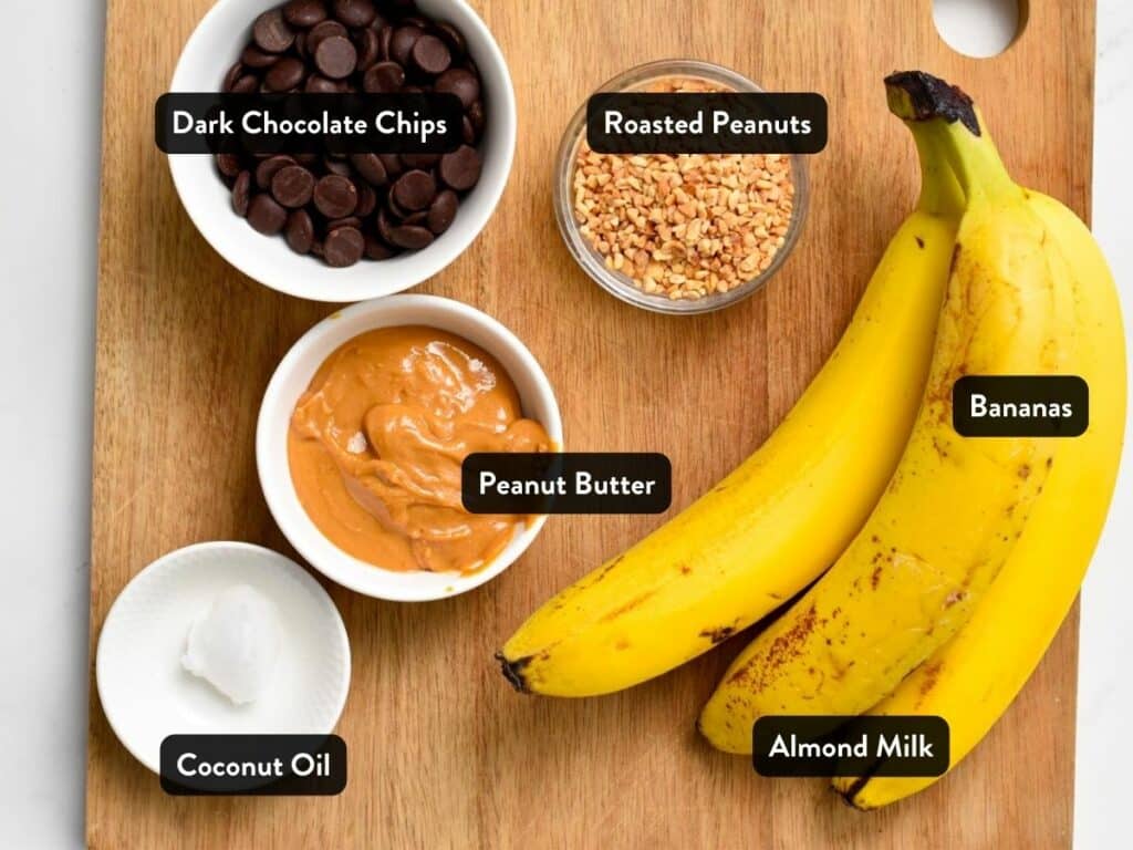 Ingredients for Chocolate Peanut Butter Banana Bites in various bowls and ramekins on a chopping board - with labels.