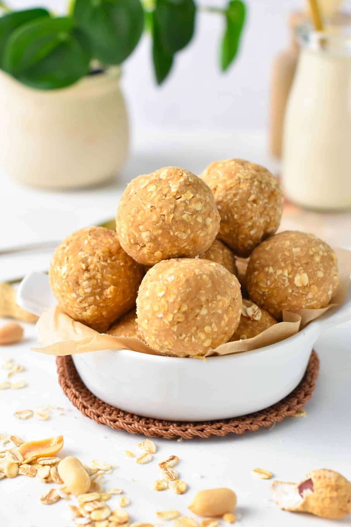 A bowl filled with lots of protein balls made with oats.