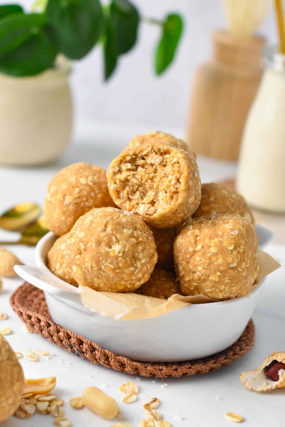 A bowl filled with lots of protein balls made with oats.