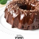 a chocolate Bundt Cake on a cake stand with drippy chocolate ganache