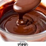 a spoon drizzling chocolate ganache in a glass bowl filled with a large batch of vegan chocolate ganache