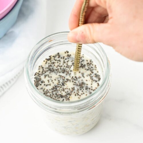 Adding liquid to the base overnight oat recipe in a jar.