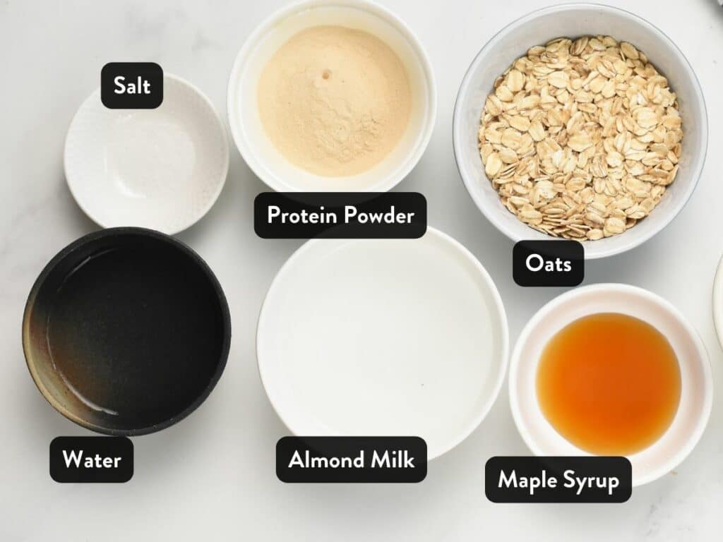 Ingredients for Protein Oatmeal in various bowls and ramekins.