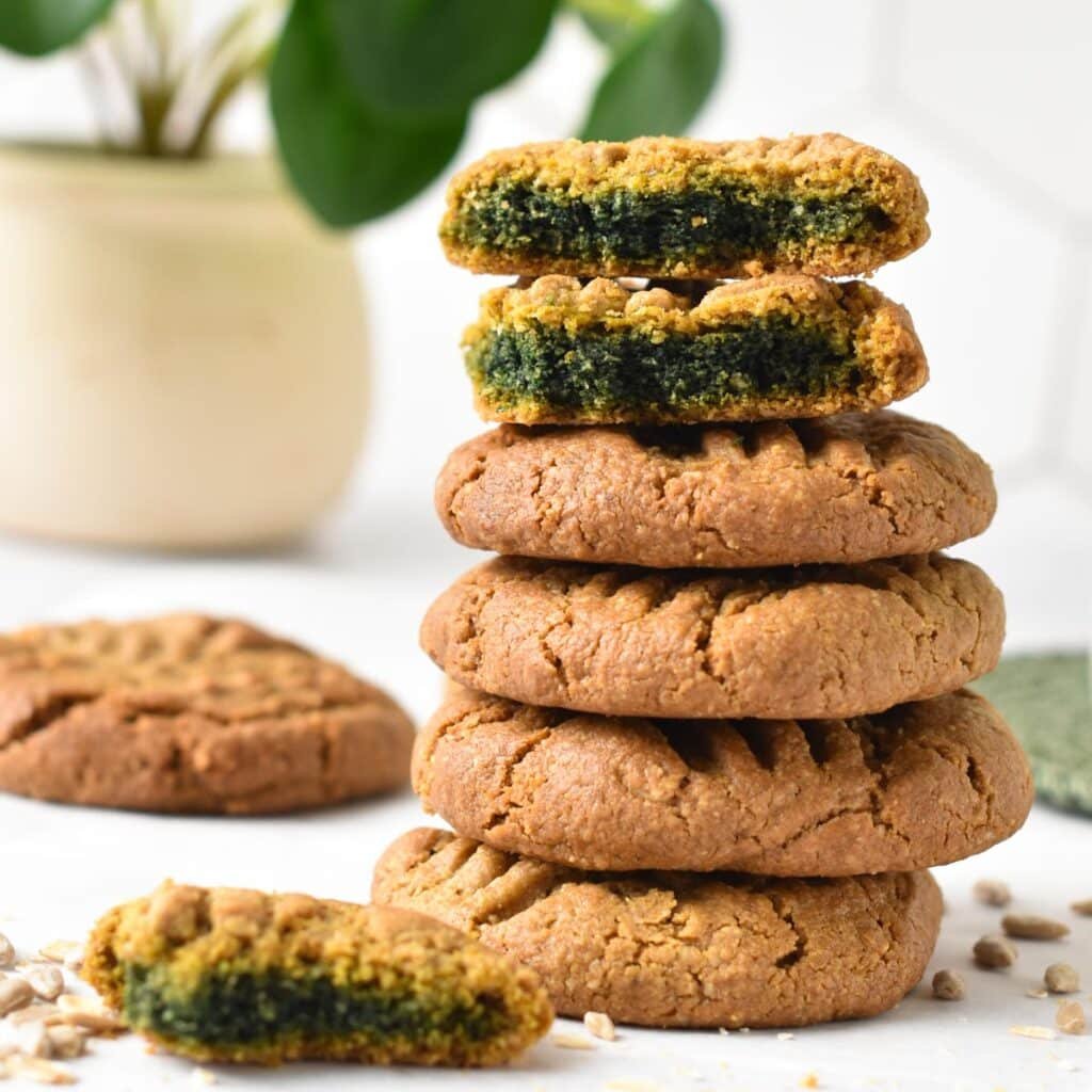 a stack of sunflower seed butter cookies showing the vibrant green cookie crumb after the cookie cool down